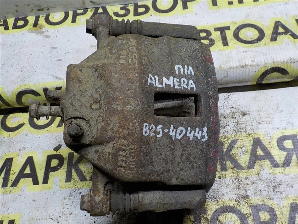Суппорт передний левый Nissan Almera (N16) 2000-2006