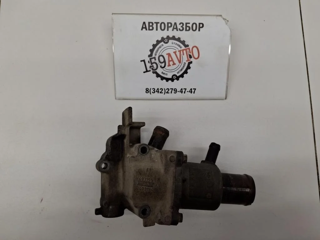 Корпус термостата Renault Logan 1