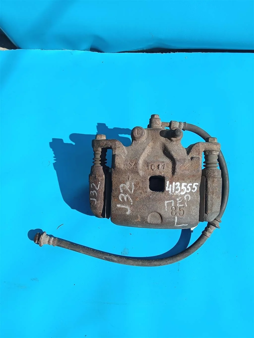 Суппорт тормозной передний левый Nissan Teana J32