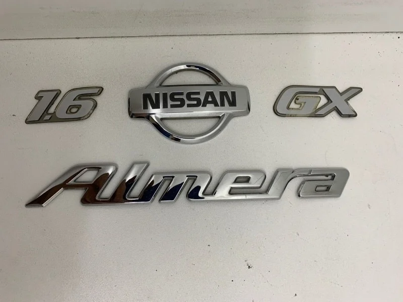 Эмблема Nissan Almera 2012-2018 84890EW000 G15
