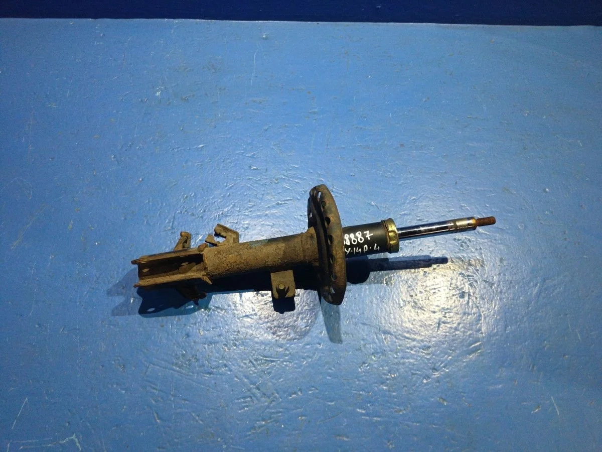 Амортизатор передний левый Nissan Note E11 (2005—2009) б.у